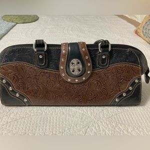 M.C. Tooled and studded leather handbag. Well used but in beautiful condition.